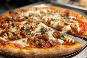 buffalo pizza with thick crust and cup-and-char pepperoni beside Detroit-style pizza with crispy cheese edges and tangy sauce