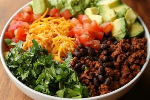 "Taco Bell Power Bowl with grilled chicken, black beans, rice, guacamole, and fresh vegetables in a bowl"

