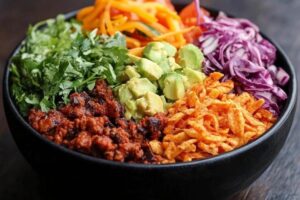 "Taco Bell Power Bowl with grilled chicken, black beans, rice, guacamole, and fresh vegetables in a bowl"

