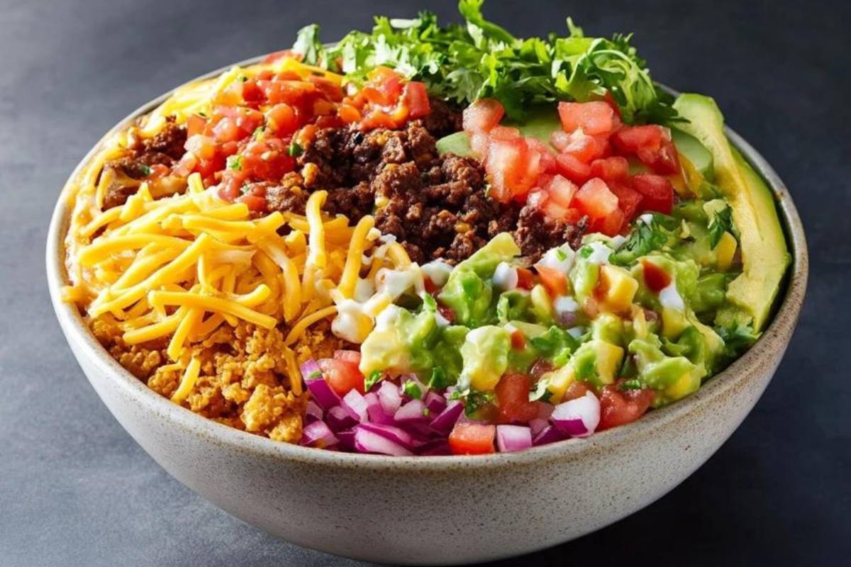 "Taco Bell Power Bowl with grilled chicken, black beans, rice, guacamole, and fresh vegetables in a bowl"