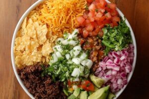 "Taco Bell Power Bowl with grilled chicken, black beans, rice, guacamole, and fresh vegetables in a bowl"

