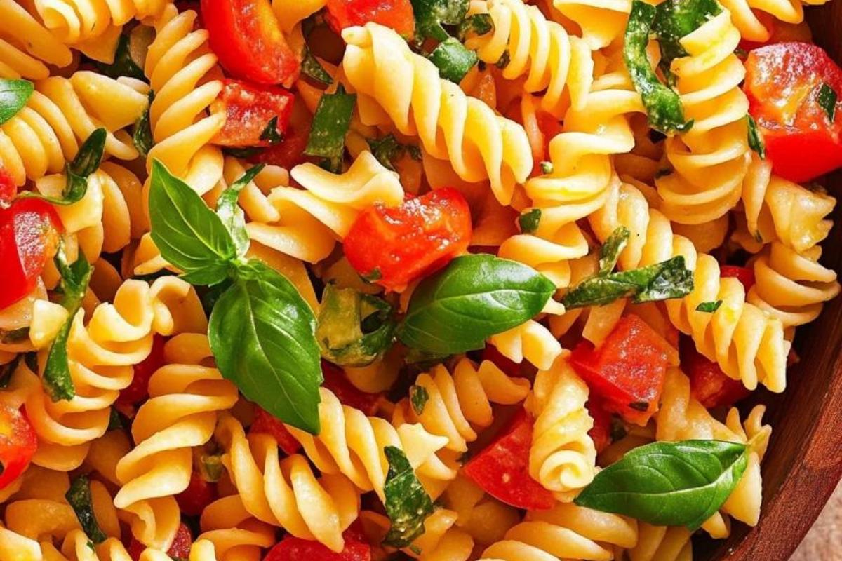 "A vibrant pasta salad with fusilli, vegetables, and fresh herbs, demonstrating the perfect texture and color balance."