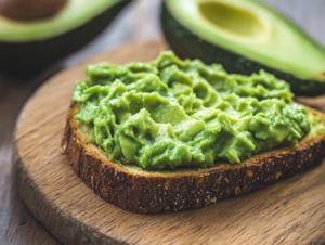 Creamy avocado spread on crispy toast topped with fresh ingredients like eggs, tomatoes, and herbs.