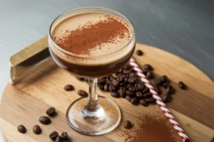 "A close-up of a freshly made Espresso Martini in a chilled glass, garnished with three coffee beans."