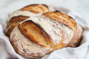 Freshly baked sourdough bread loaf with a crispy crust, showcasing the texture and health benefits of fermented bread.