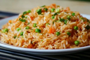 A close-up of golden, crispy fried rice in a wok with vegetables and protein, highlighting the perfect texture. 