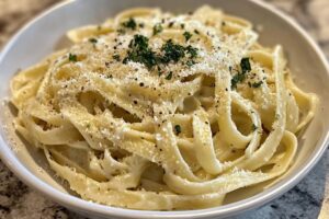 What can I add to Alfredo pasta to make it taste better