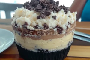 German Chocolate Poke Cake with coconut-pecan frosting and chocolate ganache on top







