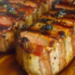 Bacon brown sugar pork tenderloin wrapped in crispy bacon with caramelized brown sugar glaze.