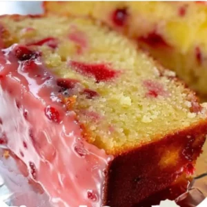 Pineapple Strawberry Pound Cake 5 iymarecipes Image of a moist pineapple strawberry pound cake with slices of pineapple and fresh strawberries on top.