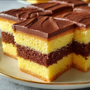Moist vanilla cake sliced to reveal a rich chocolate filling inside.