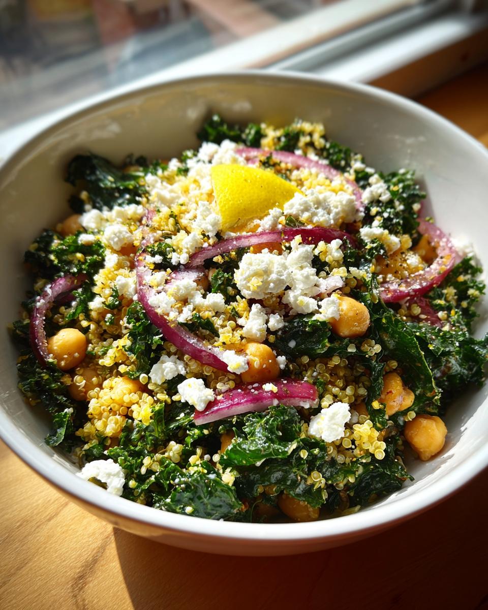 A vibrant Quinoa Kale Power Bowl with lemon, chickpeas, red onion, and feta cheese.