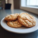 Three Soft-Baked Maple Brown Sugar Cookies on a white plate, ready to eat.
