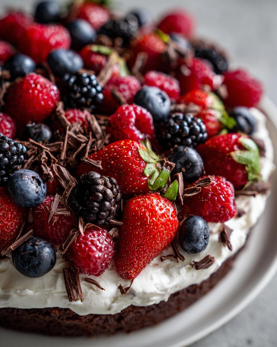 Close-up of a delicious dessert cake topped with fresh berries, perfect for the Easiest Dessert.