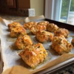 Close-up of freshly baked Baked Salmon Cat Bites on parchment paper, ready to serve.