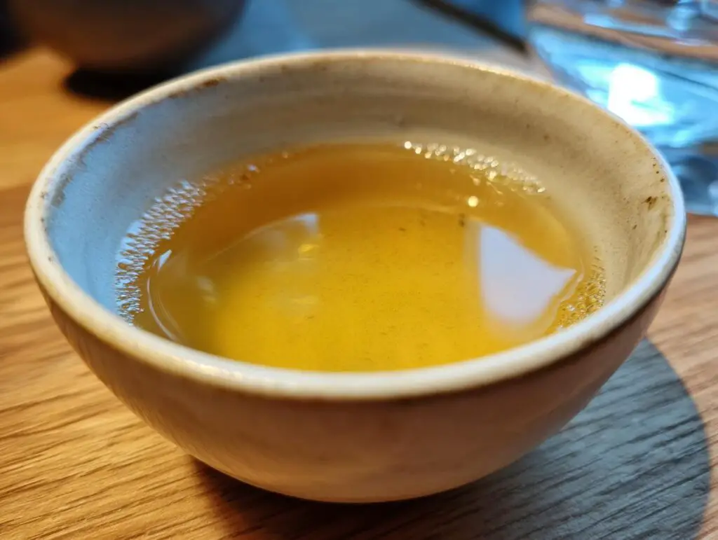Close-up of a bowl filled with homemade fish broth, perfect for a Fish Broth Cat Recipe.