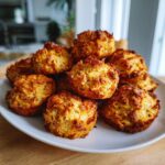 A pile of golden-brown Grain-Free Cat Treats on a white plate, ready to be enjoyed.