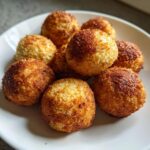 Close-up of a plate of homemade Grain-Free Fish Cat Treats, golden and crispy.
