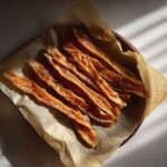 Overhead shot of homemade salmon skin cat treats on parchment paper, the perfect salmon skin cat treats.