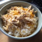A bowl of homemade Sensitive Stomach Cat Meal with shredded chicken and rice.