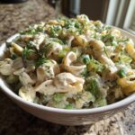 Close-up of a bowl of pasta salad dill pickle with pasta, dill, and creamy dressing.