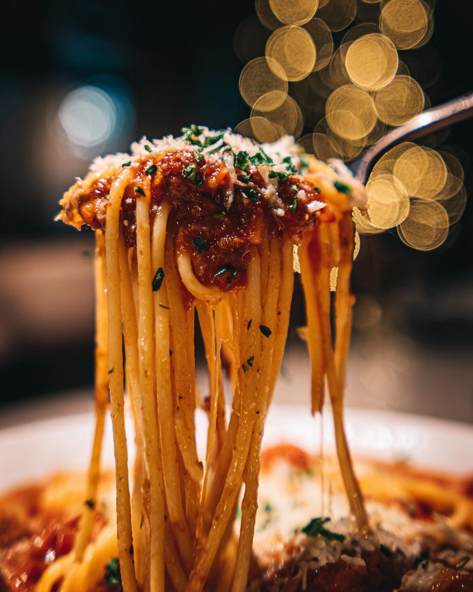 Close-up of pasta with sauce and cheese, potentially for a pasta salad that keeps well recipe.