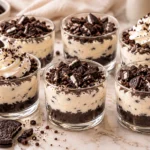 No-bake mini Oreo cheesecake cups with a chocolate cookie crust, creamy filling, and crushed Oreo topping.